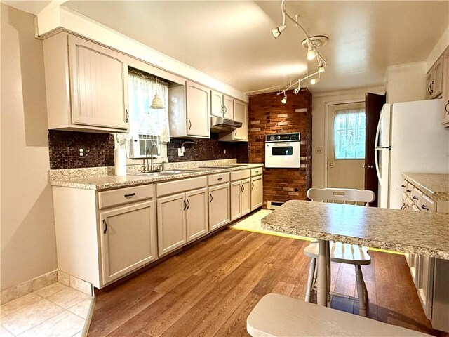 226 Cottage Ave, Masontown, PA 15461 - kitchen featuring white appliances, light countertops, tasteful backsplash, and under cabinet range hood