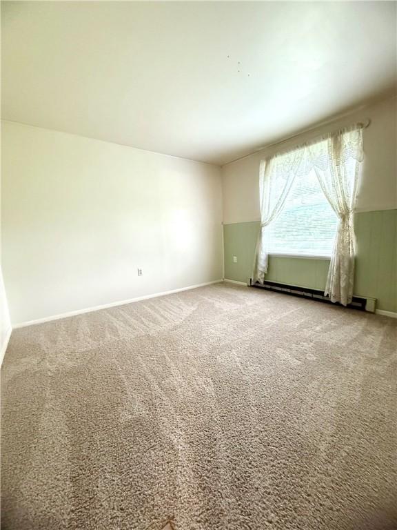 226 Cottage Ave, Masontown, PA 15461 - spare room featuring carpet flooring, baseboards, and a baseboard heating unit