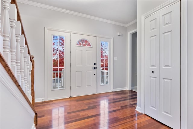 entryway with crown molding and dark hardwood / wood-style flooring