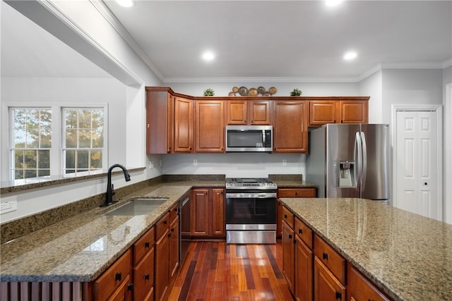 kitchen with dark wood-type flooring, sink, crown molding, stone counters, and appliances with stainless steel finishes