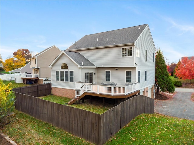 rear view of property with a wooden deck