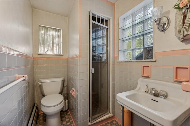 bathroom featuring an enclosed shower, tile patterned flooring, sink, tile walls, and toilet