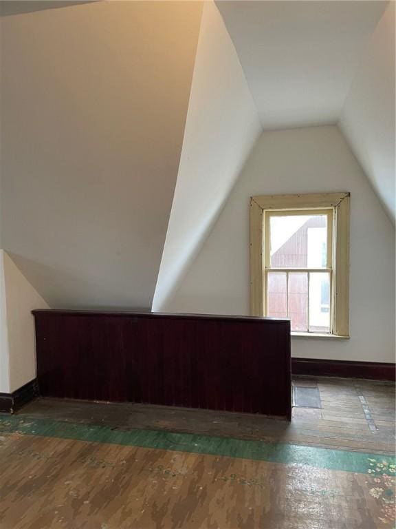 bonus room with lofted ceiling and dark hardwood / wood-style floors