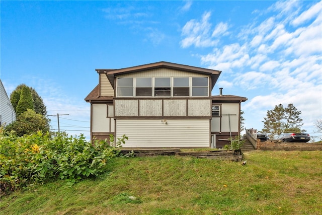 rear view of house with a yard