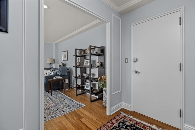 entrance foyer with hardwood / wood-style floors and crown molding