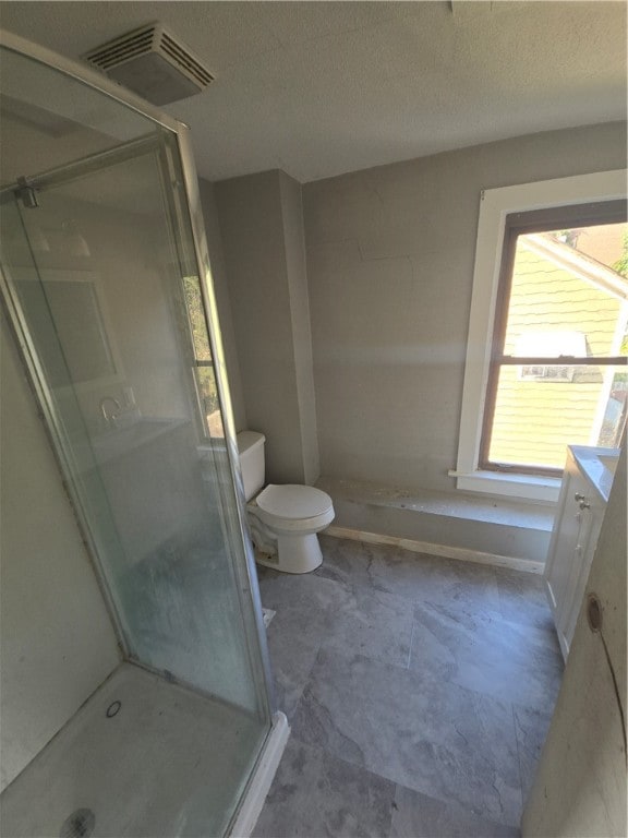 bathroom featuring vanity, toilet, a textured ceiling, and an enclosed shower