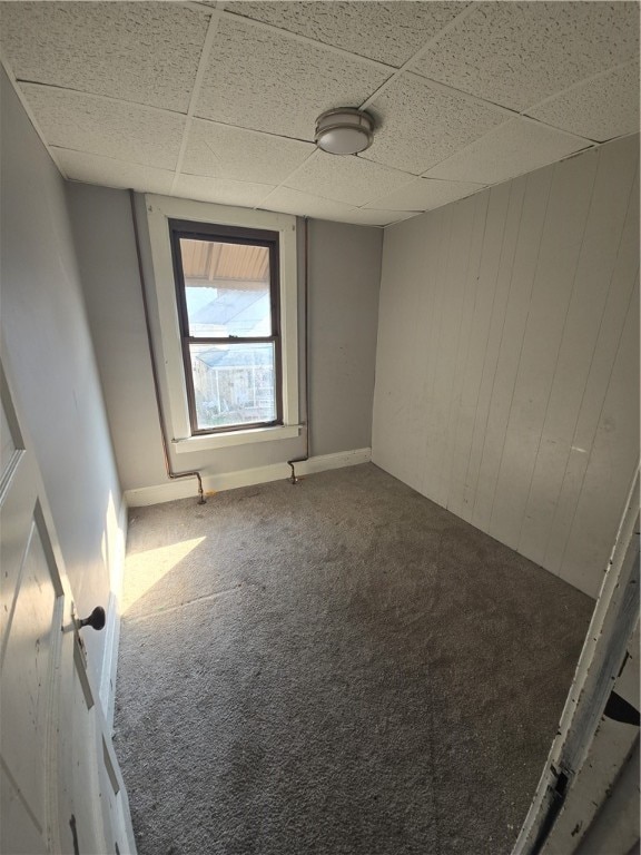 carpeted spare room with a paneled ceiling