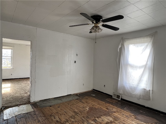 spare room featuring ceiling fan and dark hardwood / wood-style flooring