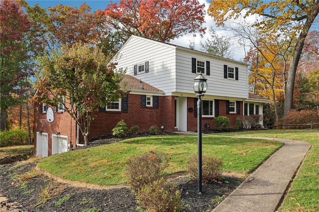 view of front property with a garage and a front lawn