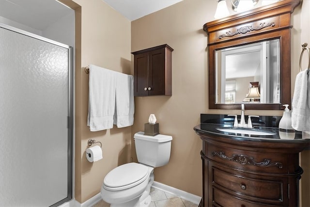 bathroom with vanity, toilet, tile patterned floors, and a shower with door