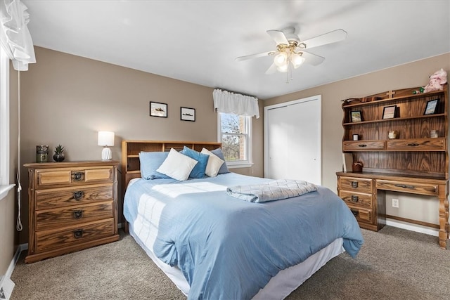 carpeted bedroom featuring a closet and ceiling fan