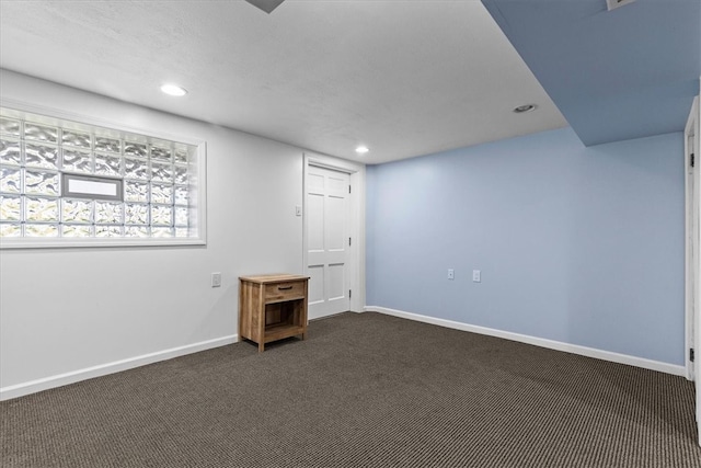 basement with dark carpet