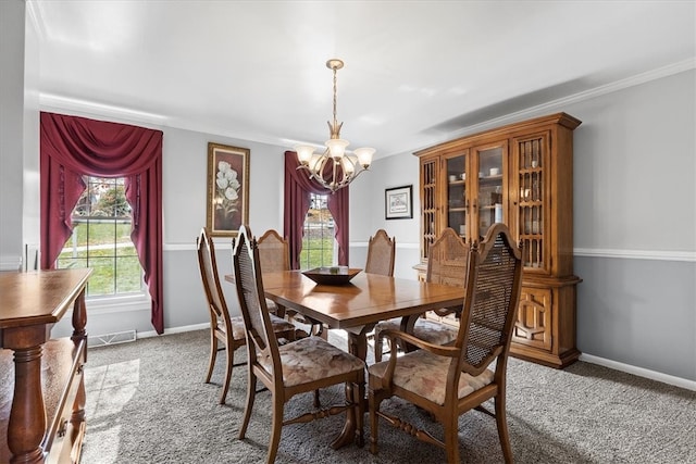 carpeted dining area featuring ornamental molding and a notable chandelier