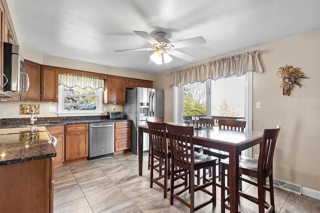 kitchen with ceiling fan and stainless steel appliances