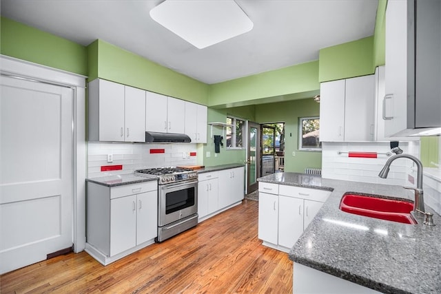 kitchen with sink, stainless steel range, light hardwood / wood-style flooring, and white cabinets