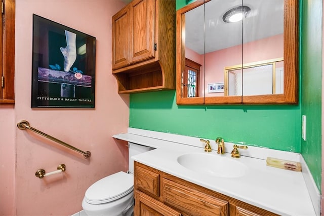 bathroom featuring toilet and vanity