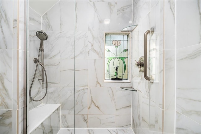 bathroom featuring a shower with door