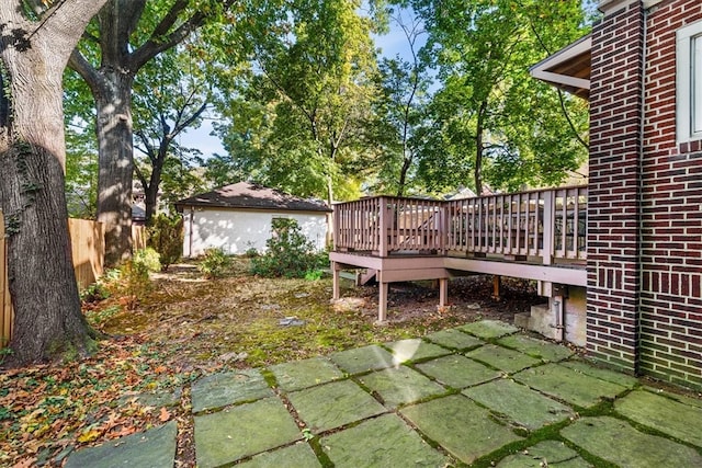 view of yard with a deck and a patio