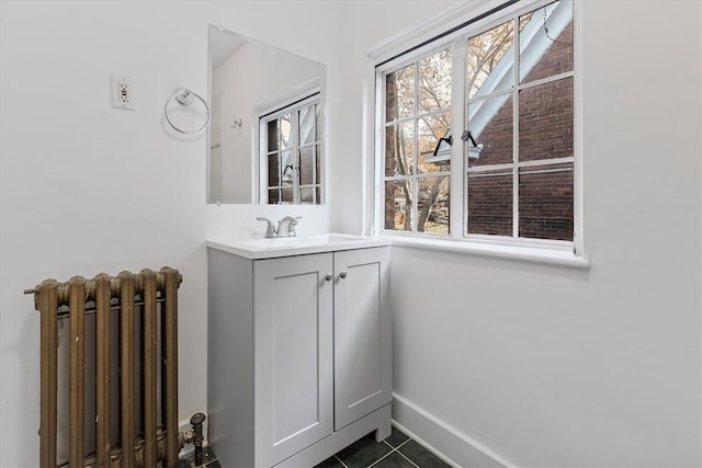 bathroom featuring vanity, tile patterned floors, and radiator