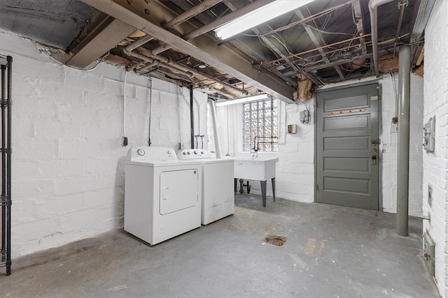 basement featuring sink and washing machine and dryer