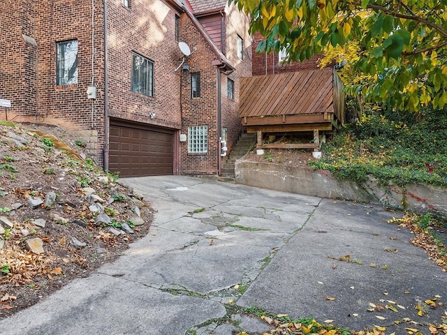 exterior space featuring a wooden deck and a garage