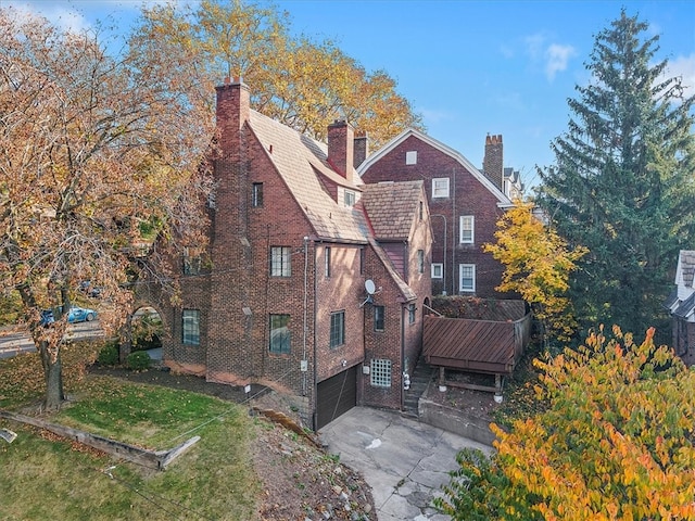 rear view of house featuring a yard and a garage