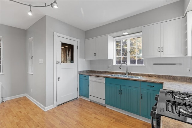 kitchen featuring white cabinetry, light wood-type flooring, dishwasher, stainless steel range, and sink