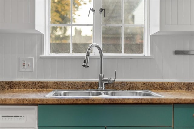 interior details featuring dishwasher, sink, and green cabinetry