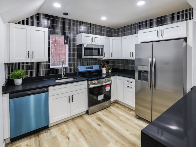 kitchen featuring light wood-type flooring, white cabinetry, sink, and appliances with stainless steel finishes