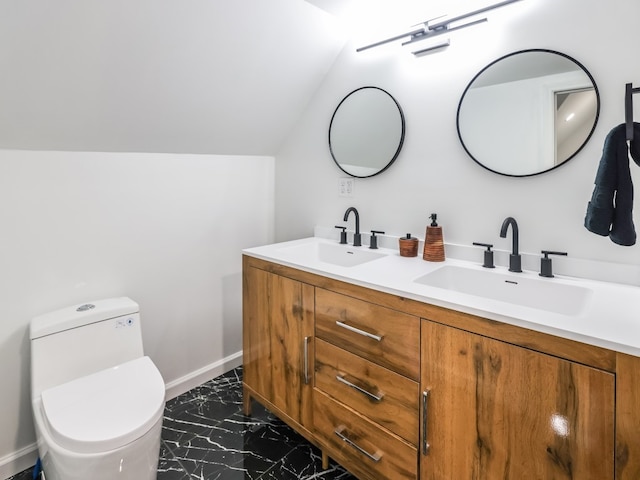 bathroom featuring vanity, lofted ceiling, and toilet