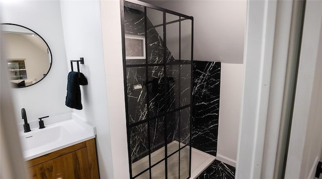 bathroom with vanity and tiled shower