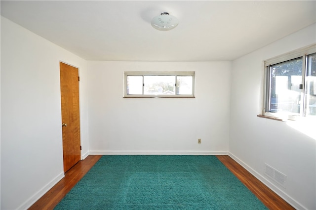 empty room featuring dark hardwood / wood-style flooring