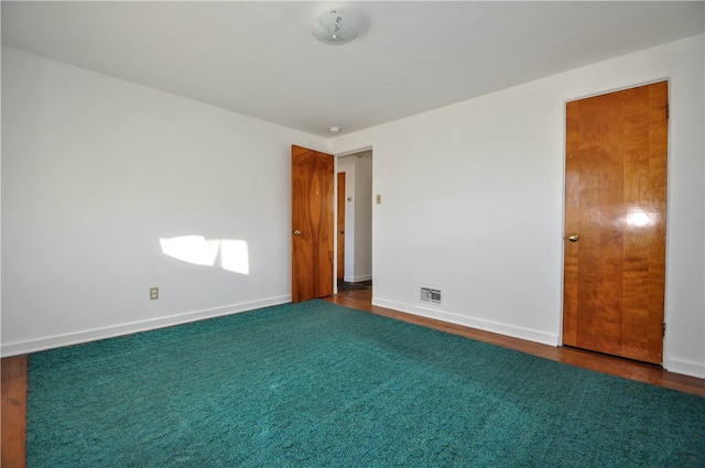 unfurnished room featuring dark hardwood / wood-style flooring