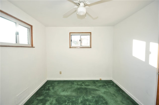 carpeted empty room with a healthy amount of sunlight and ceiling fan