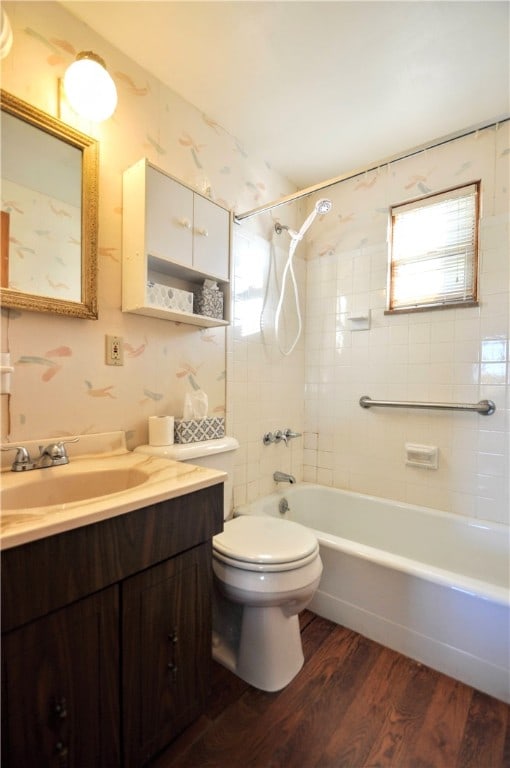 full bathroom featuring vanity, wood-type flooring, toilet, and plenty of natural light