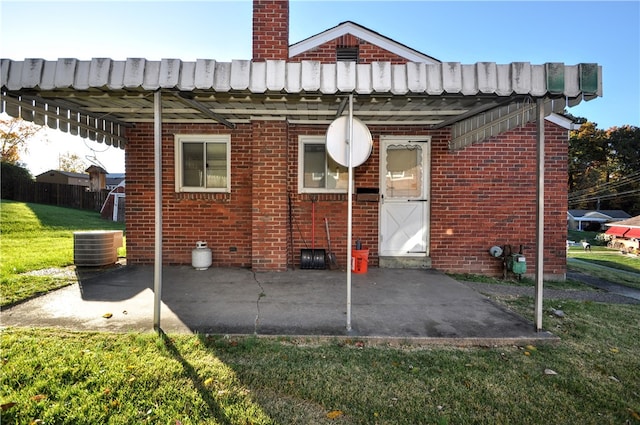 back of property featuring a yard, a patio, and central AC unit