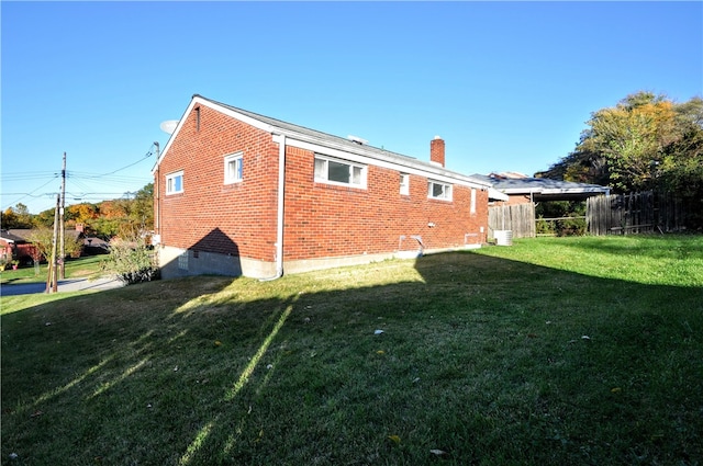 rear view of property with a yard