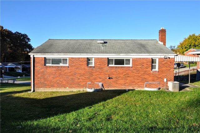 view of side of home featuring a yard, cooling unit, and a pergola