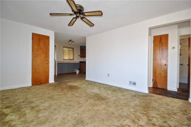 carpeted spare room with ceiling fan