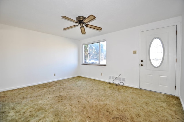 carpeted foyer entrance with ceiling fan