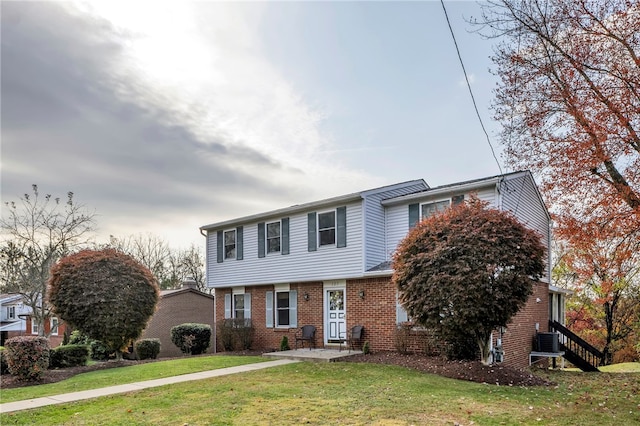 view of front facade featuring a front lawn and central AC unit