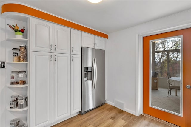 kitchen featuring white cabinetry, light wood-type flooring, and stainless steel fridge with ice dispenser