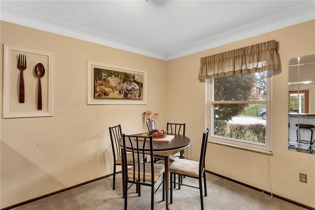 dining room featuring light carpet and ornamental molding