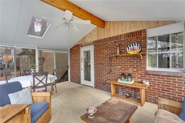 sunroom / solarium featuring vaulted ceiling with skylight and ceiling fan