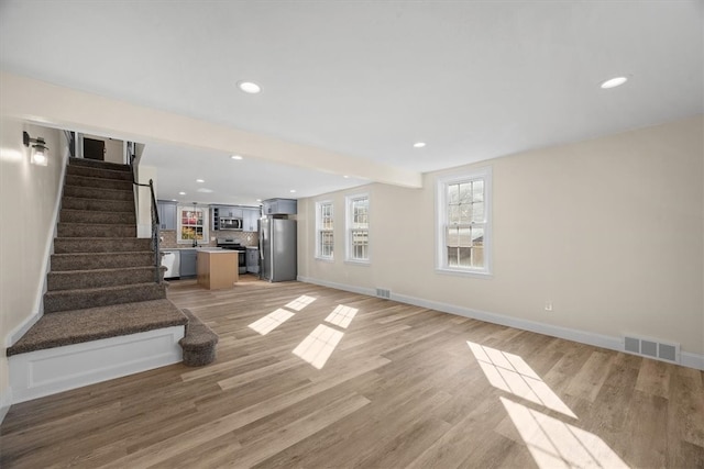 unfurnished living room with light wood-type flooring