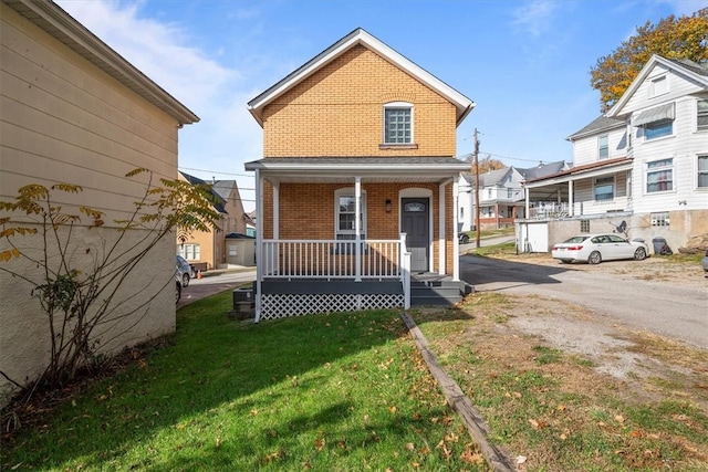 view of front facade featuring a front lawn and covered porch