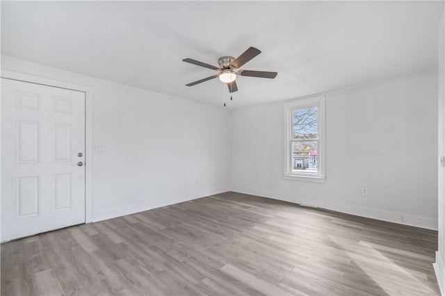 spare room featuring light hardwood / wood-style floors and ceiling fan