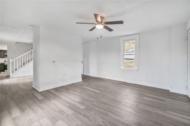 unfurnished room featuring ceiling fan and hardwood / wood-style floors