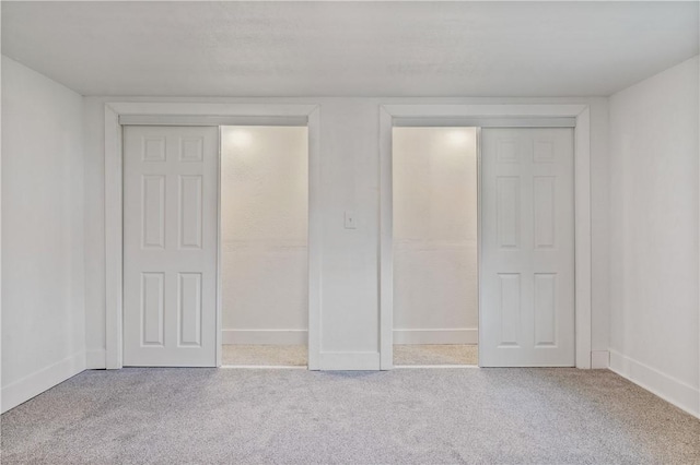 unfurnished bedroom featuring carpet floors and baseboards