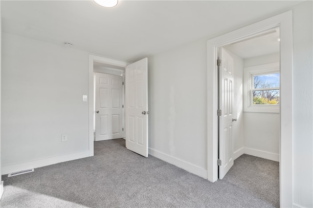 unfurnished bedroom featuring light carpet